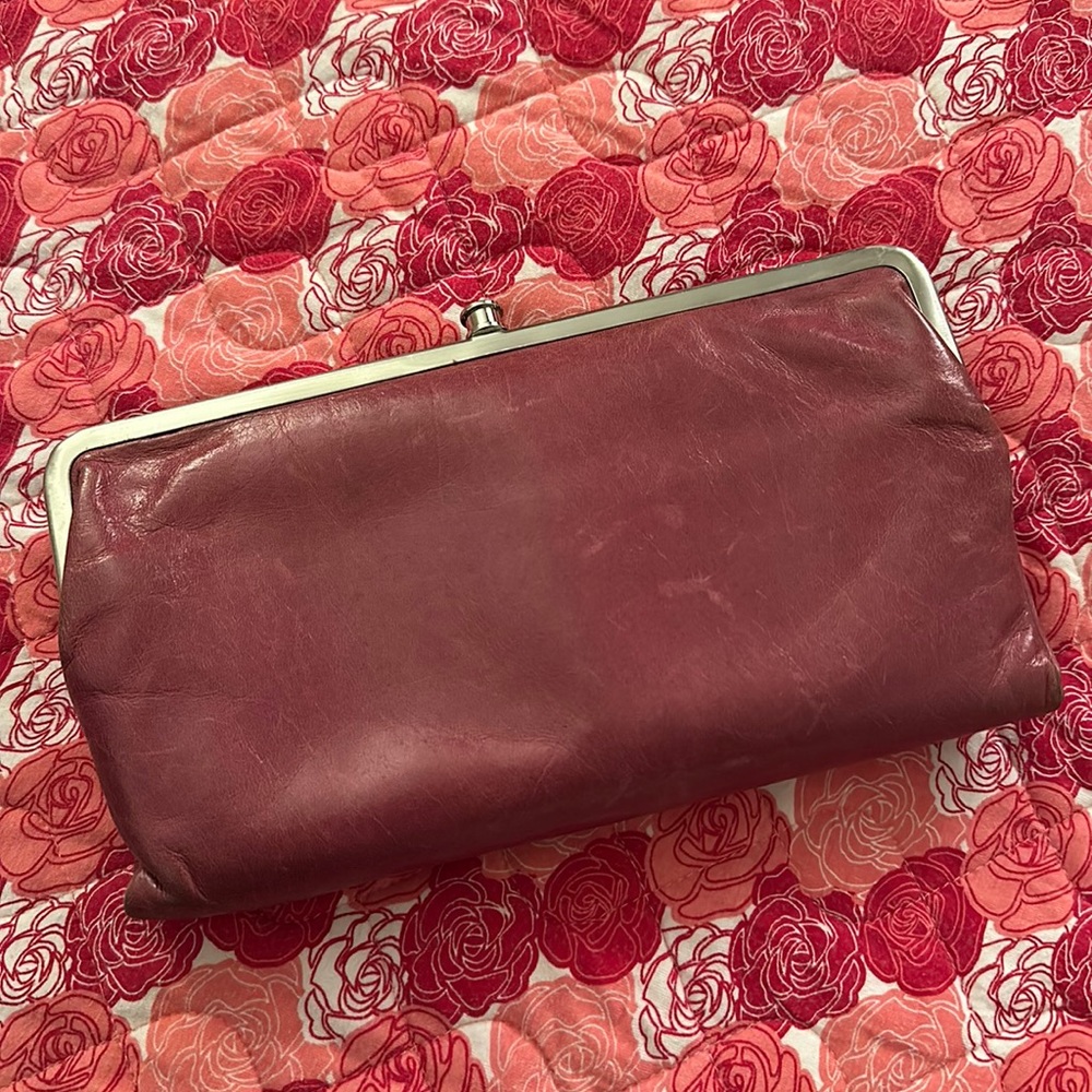 Hobo wallet in a pink color with a tan brown interior design. Great condition!